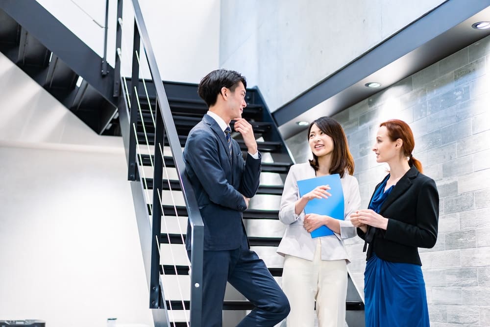 階段で会話をする会社員の男女