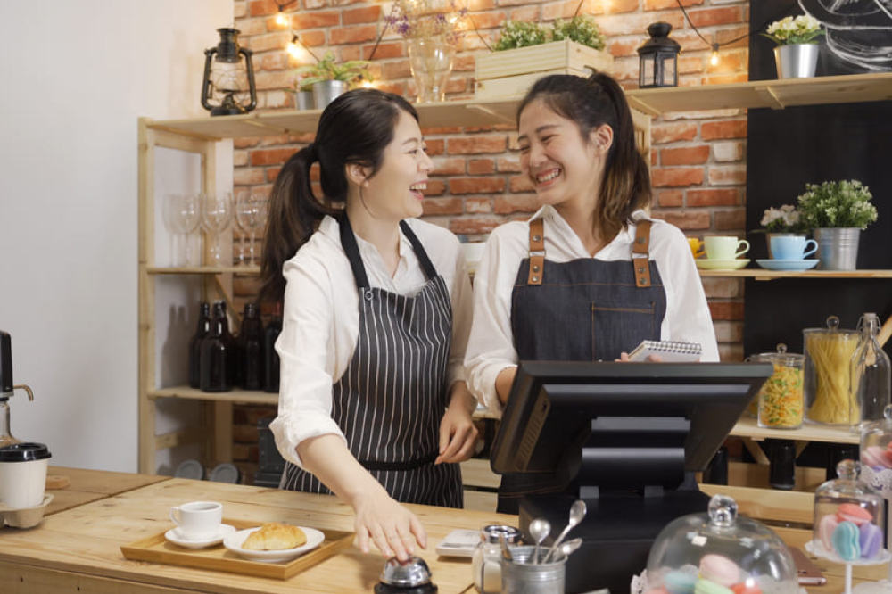 カフェのレジで楽しそうにはなす二人の女性